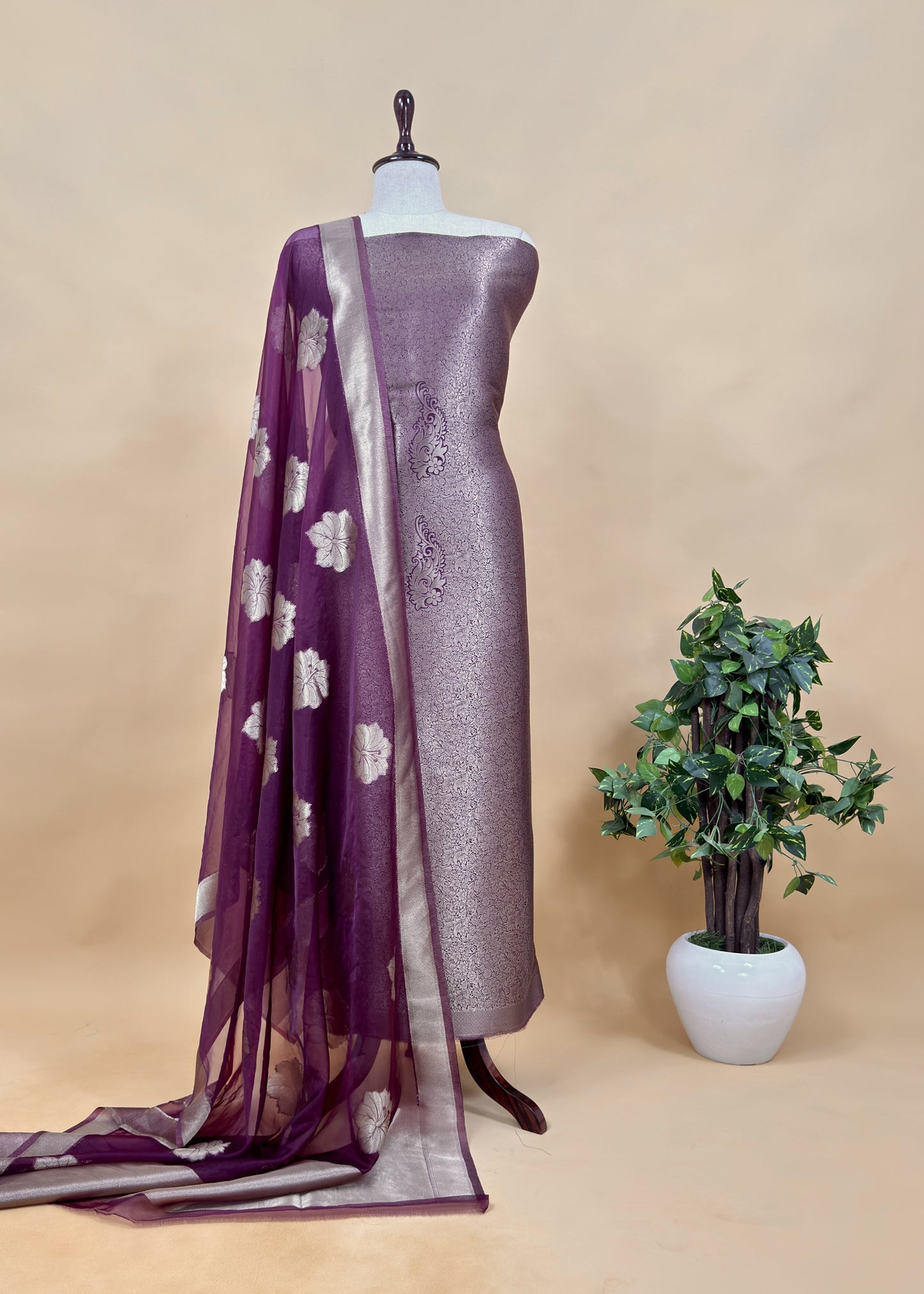 PurpleThe wedding wear three-piece suit has brocade kurta and organza Dupatta