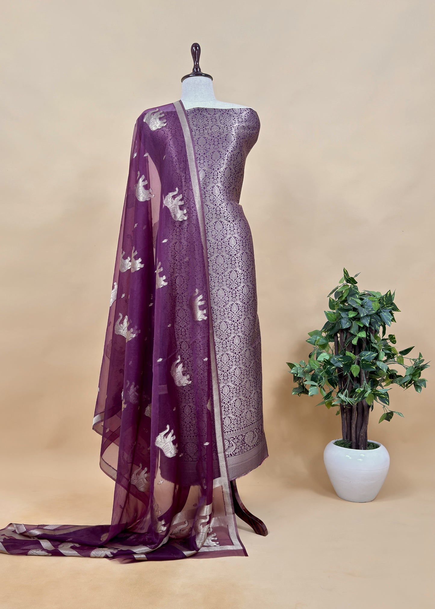 PurpleThe wedding wear three-piece suit has brocade kurta and organza Dupatta