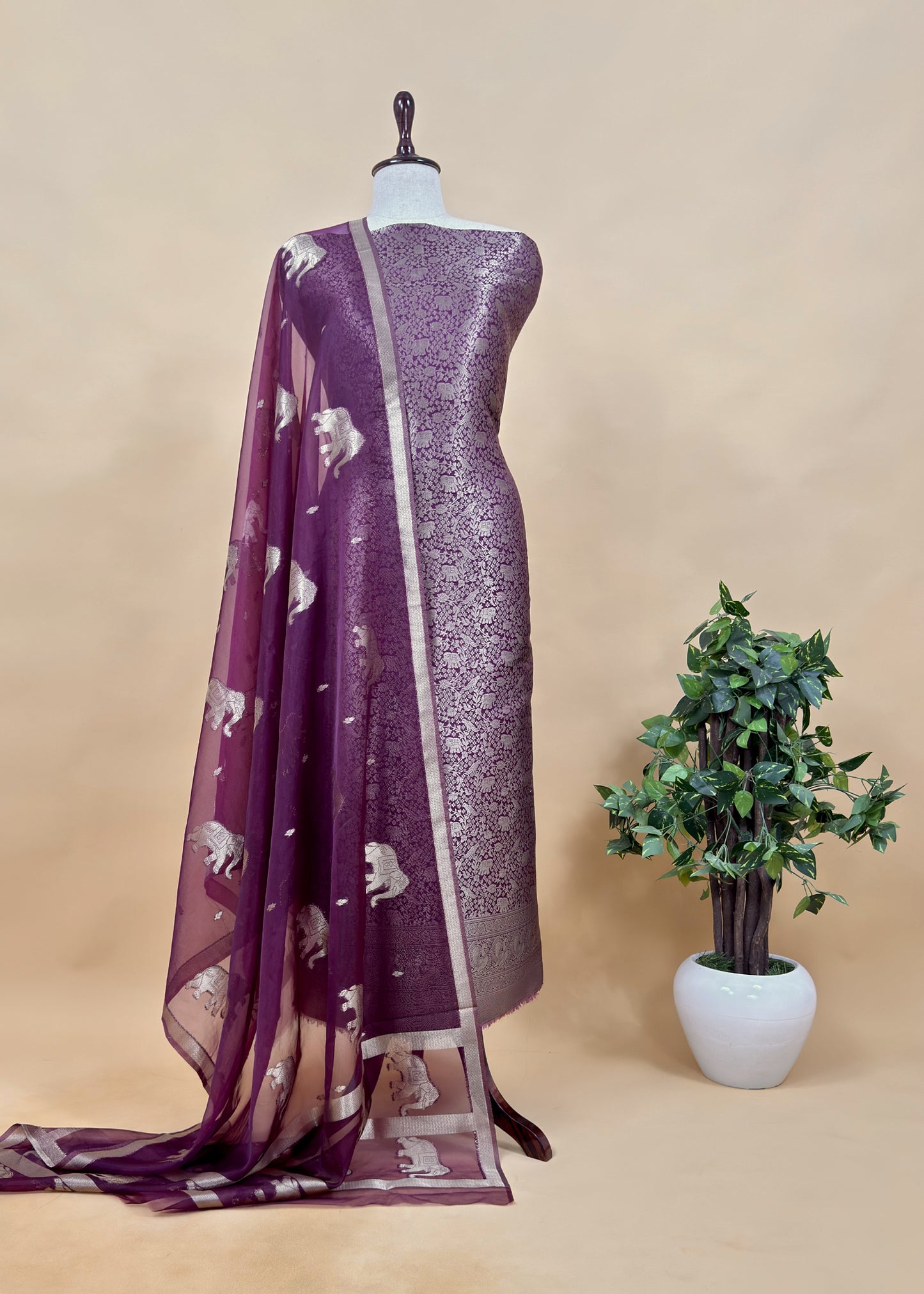 PurpleThe wedding wear three-piece suit has brocade kurta and organza Dupatta