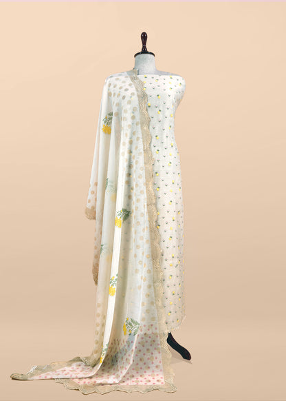 White With Yellow Embroidered Unstitched Mulmul Suit With Scalloped Border.
