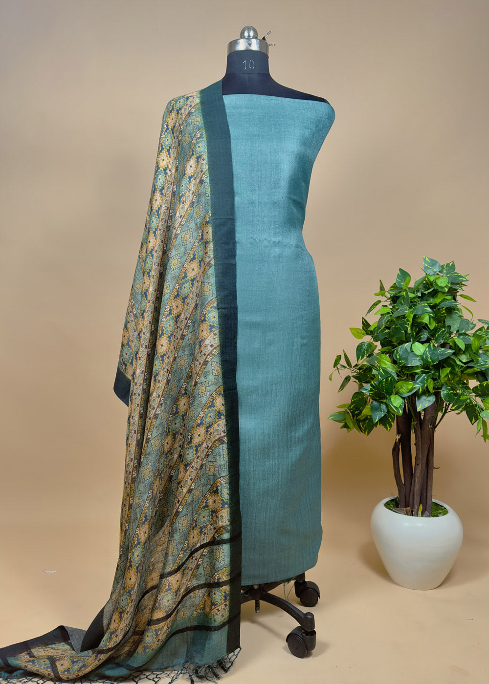 Model wearing a Green brocade kurta with intricate embroidery and a matching organza dupatta.