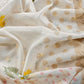 White With Yellow Embroidered Unstitched Mulmul Suit With Scalloped Border.